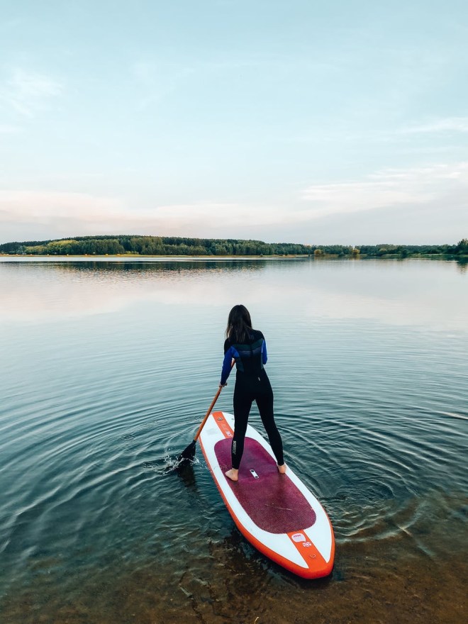 woman paddling in wetsuit